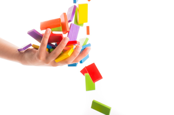 Zuhanó színes dominó egy kézre - Fotó, kép