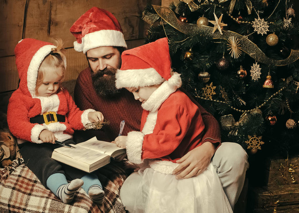 christmas family of bearded father and children in santa hat - Photo, image