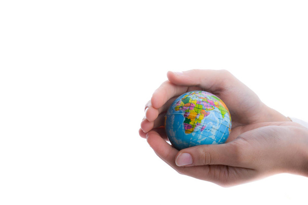 Child holding a small globe in hand on white background - Foto, imagen