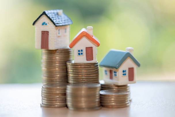 Mini house on stack of coins,Money and house,  Mortgage, Savings money for buy house and loan to business investment for real estate concept. Invesment and Risk Management. - Photo, Image