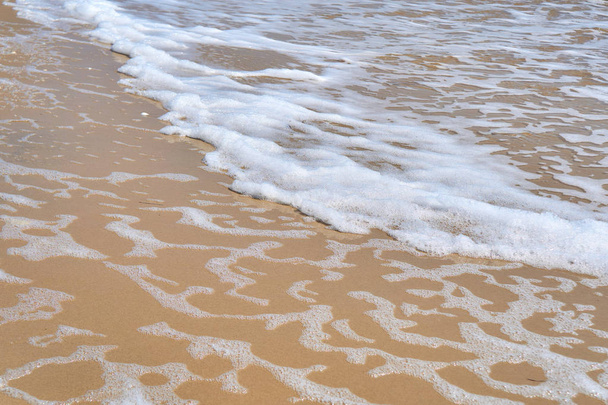 Soft wave of the sea on the sandy beach as background. - Photo, Image