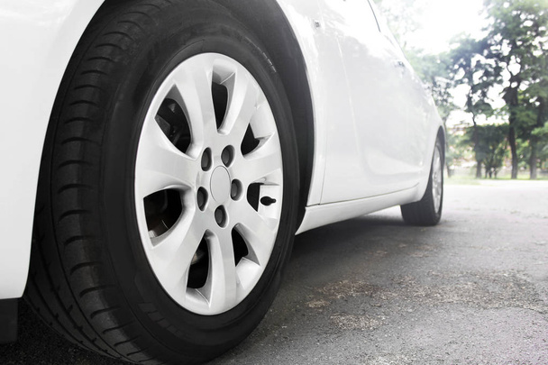 Car wheels close up on a background of asphalt - Fotografie, Obrázek