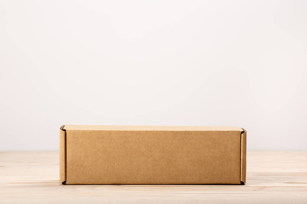 blank label cardboard box  on wooden table - Zdjęcie, obraz