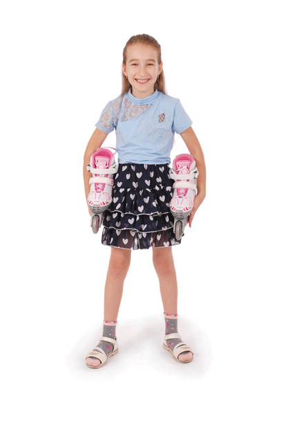 Happy little girl holds in hands roller skates isolated on white background - Foto, afbeelding