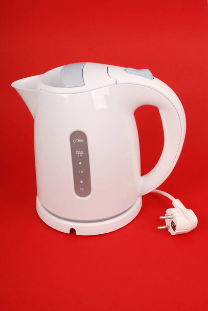 White electric kettle isolated on red background - Photo, Image