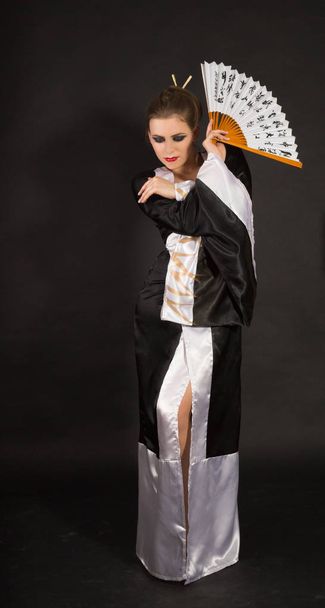 Beautiful green-eyed girl in a Japanese kimono  - Фото, зображення