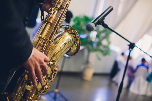 Musical instruments, Saxophone Player hands Saxophonist playing jazz music. Alto sax musical instrument closeup. - Foto, afbeelding
