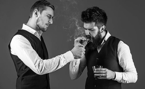 Friend, business partner, assistant helping man with beard light cigar. - Fotografie, Obrázek