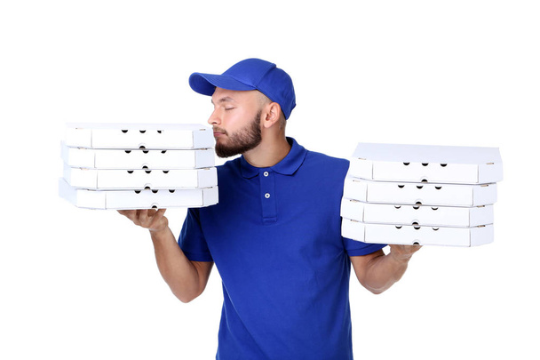 Delivery man with pizza in cardboard boxes isolated on white background - Foto, Imagen
