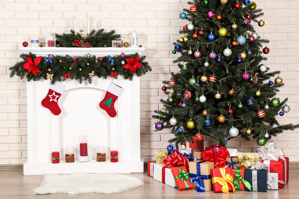 Decorated fireplace near christmas tree on brick wall background - Foto, immagini