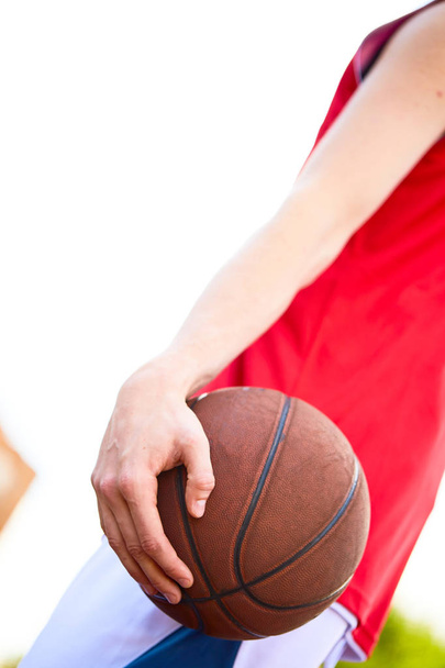 Close view of man holding basketball in hand - Foto, Imagen