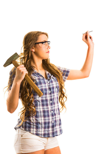 Young girl in a glasses holding  a hammer. Isolated on the white background - Fotografie, Obrázek