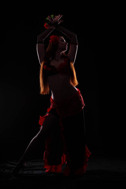 Attractive woman dancing in the darkness - Fotoğraf, Görsel