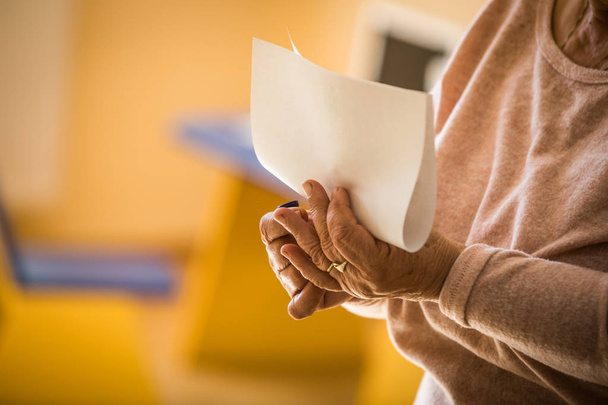 Color image of a person casting a ballot at a polling station, during elections. - Foto, Bild