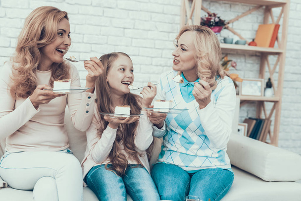 Happy Family Celebrating Birthday and Eating Cake. Cake on Table. Happy Family. Mother with Daughter. Smiling Women at Home. Smiling Grandmother. Celebration Concept. Plate in Hands. - Photo, image