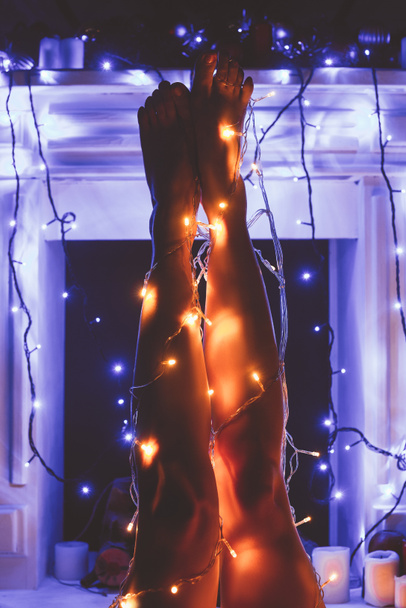 partial view of woman with christmas festive lights around - 写真・画像