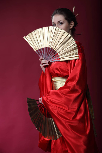 Beautiful brunette girl in a japanese kimono  - 写真・画像