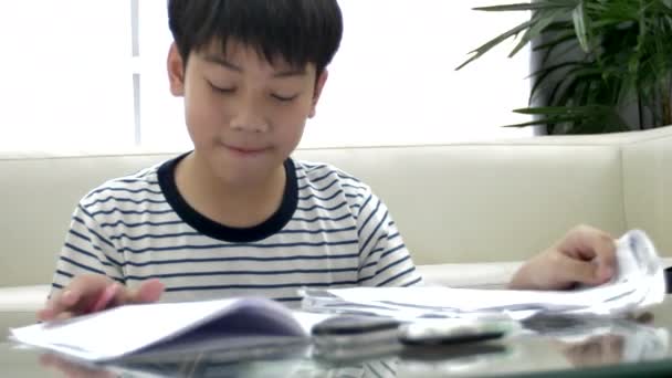 Cute asian teen boy doing your homework at home. - Footage, Video