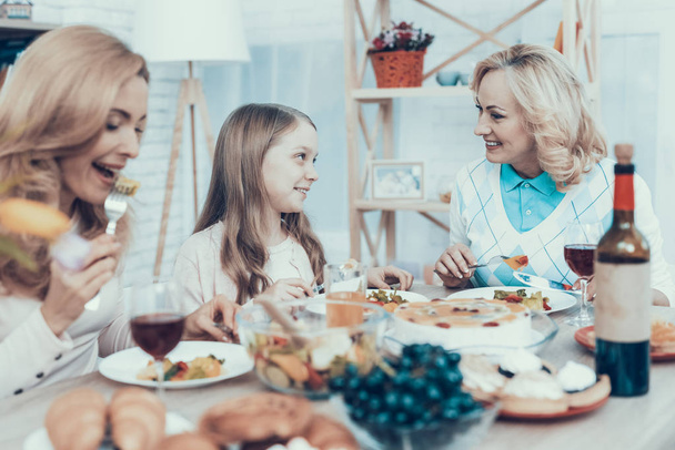 Happy Sitting Family Celebrating Birthday at Home. Cake on Table. Happy Family. Mother with Daughter. Smiling Women. Smiling Grandmother. Celebration Concept. Glass of Wine. Fruits on Plate. - Фото, изображение