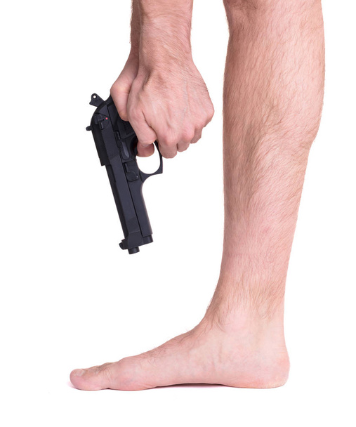 Man shooting himself in the foot - Foto, Bild