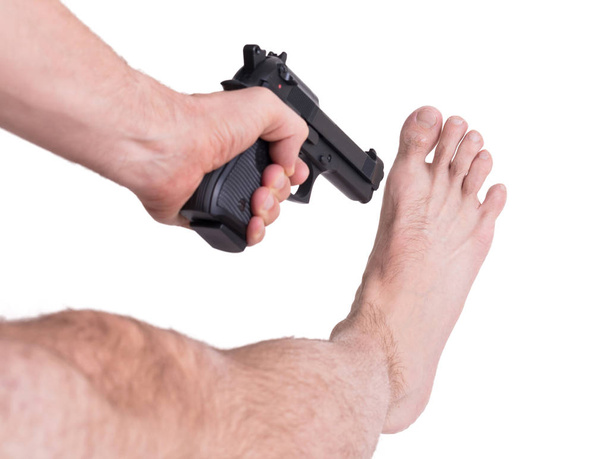 Man shooting himself in the foot - Photo, Image