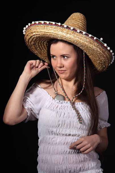 Woman in mexican costume  against dark background  - Фото, зображення