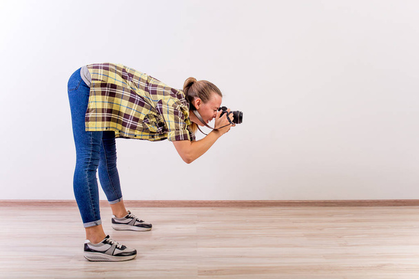 different photographer poses: bending, squatting, lying down - Fotó, kép