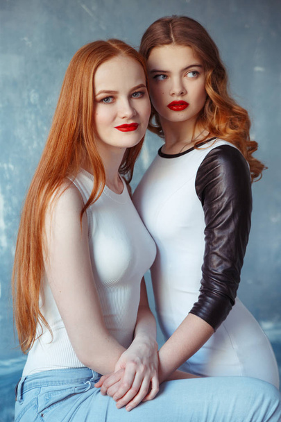 portrait of young red hair women posing in studio - 写真・画像