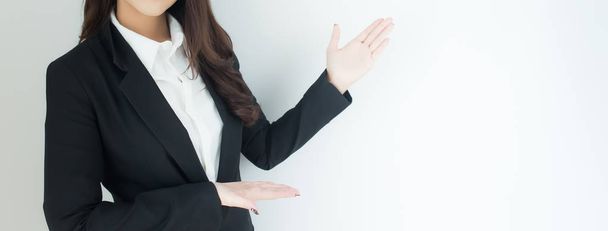 Close up of young business woman pointing up over white background. Banner with copyspace for your text. - Φωτογραφία, εικόνα