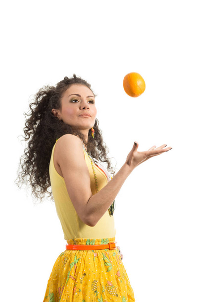 Young attractive girl with orange  isolated on the white background - Photo, Image