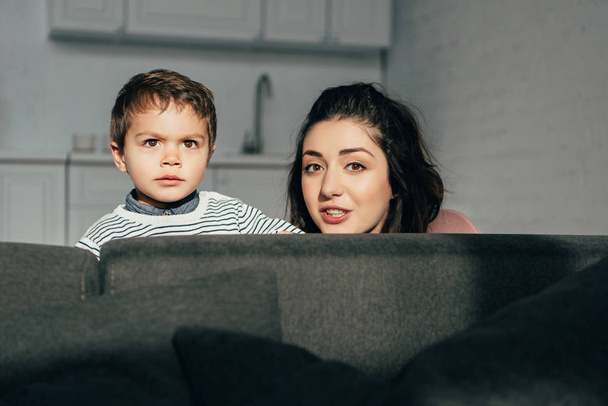portrait of mother and little son sitting on sofa at home - Foto, Imagem