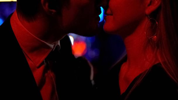 Man and woman going to kiss at night club, carefree nightlife, close-up shot - Foto, imagen