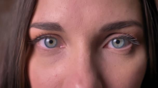 Close-up portrait of a woman, who watches into the camera and closes her eyes. - Footage, Video