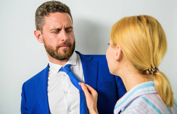 Workforce sexual harassment. Try to seduce director. Secretary sexual attention to boss. Office and sexual behavior. Woman hold mans necktie. Girl seduce colleague. Sexual harassment at workplace - Fotoğraf, Görsel