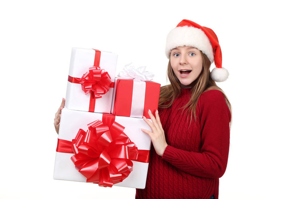 Young girl in santa hat with gift boxes isolated on white background - Foto, Imagem