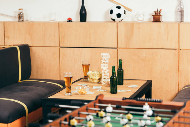 close up view of beer, snacks and blocks wood game on tabletop in cafe - Fotó, kép