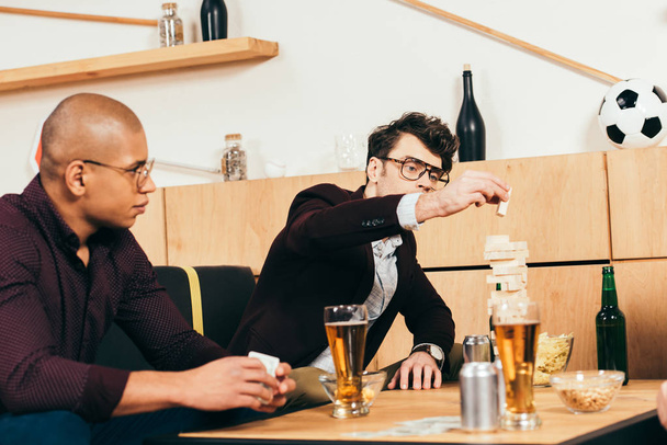multiethnic businessmen with beer playing blocks wood game in cafe - Valokuva, kuva