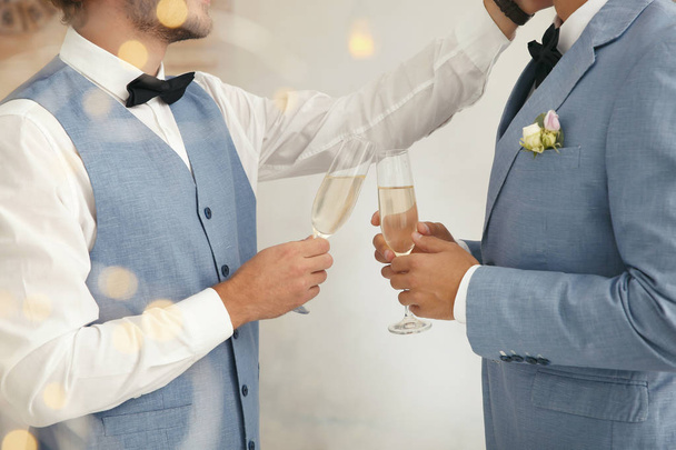 Newlywed gay couple with glasses of champagne at home, closeup - Photo, image