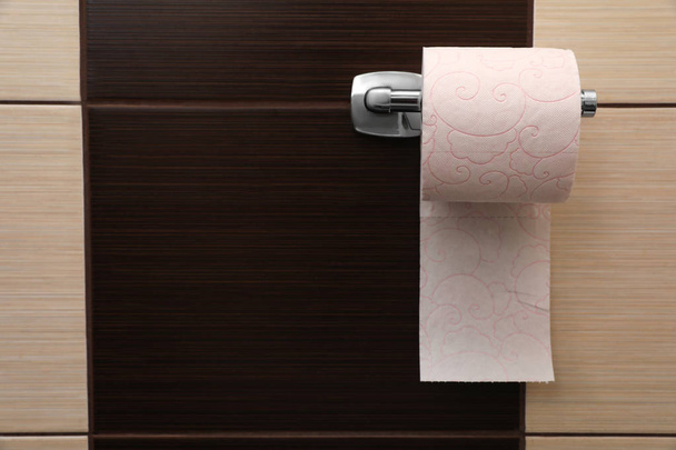 Holder with soft toilet paper roll in bathroom. Space for text - Fotoğraf, Görsel