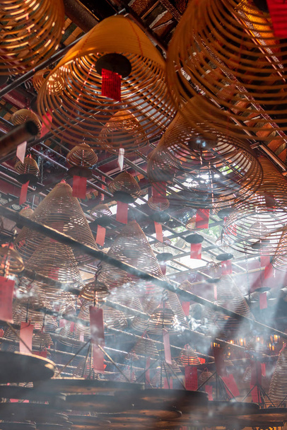Jesus Light and the hanging incenses inside the Man Mo Temple in Hong Kong - Photo, Image