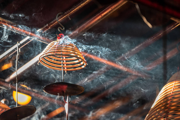 Close up photo of burning spiral candles in Man Mo Temple - Photo, Image