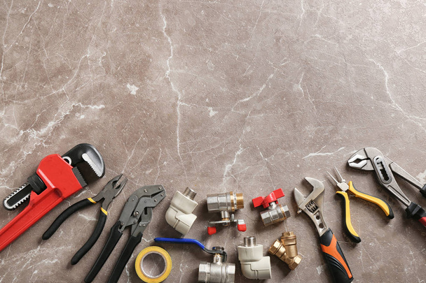 Flat lay composition with plumber's tools and space for text on grunge background - 写真・画像