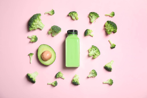 Flat lay composition with smoothie in bottle and ingredients on color background - Foto, afbeelding