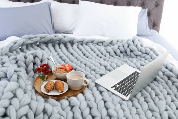 Laptop and tray with breakfast on bed. Interior element - Photo, Image