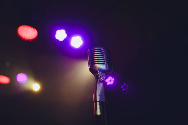 Retro microphone against blur colorful light restaurant background. - Zdjęcie, obraz