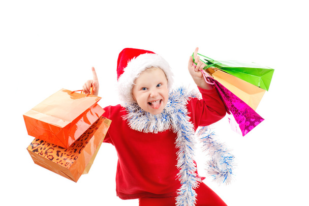 Enfant habillé en Père Noël avec des cadeaux
 - Photo, image