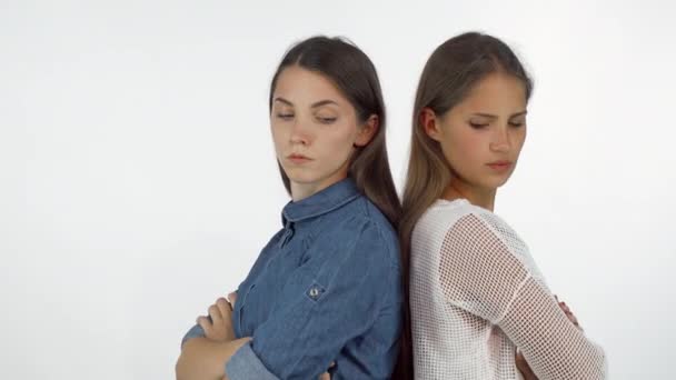 Two female friends standing back to back looking angry after having a fight - Footage, Video