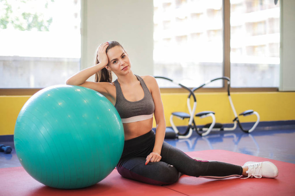 beautiful woman relaxing in the gym - Photo, image