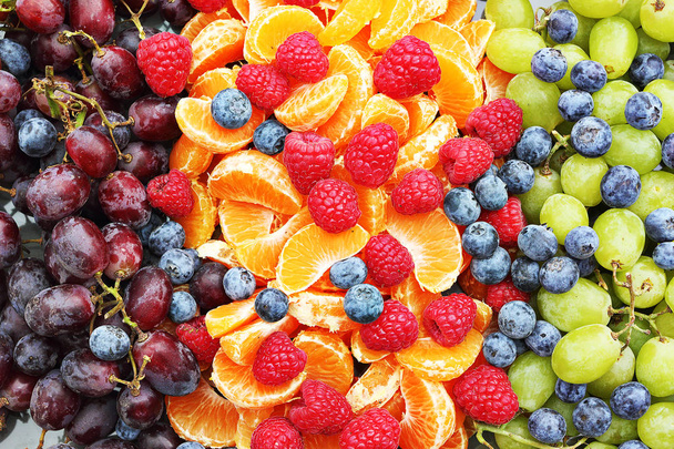 bunch of forest fruits, grapes, raspberry, oranges, cranberries - Photo, Image