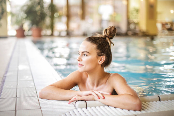 young woman relaxing in the pool - Fotó, kép